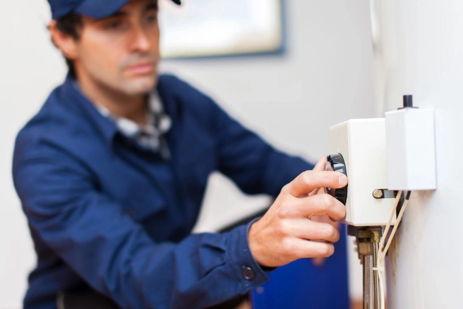 A man working on a water heater.